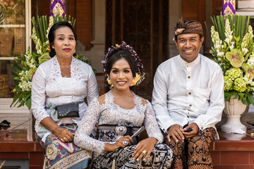 Balinese bride with parents at traditional wedding ceremony