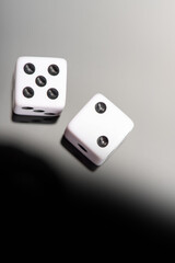 Dice, classic dice resting on reflective surface, selective focus.