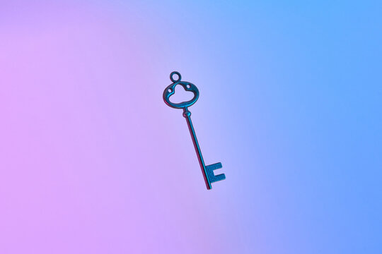 Retro key on neon gradient background.