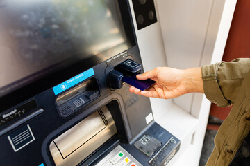 Zoomed In Shot Of Person Putting Card In ATM