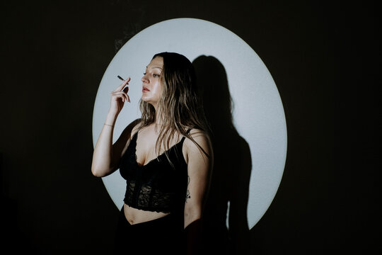 Attractive young woman smoking a cbd joint