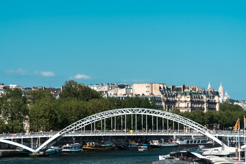 Paris, France. April 22, 2022: Debilly footbridge with Paris bridge and Seine river.
