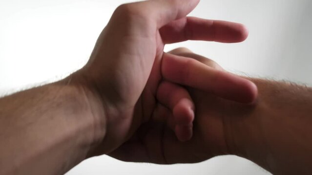 Two hands expertly crack their knuckles. The close-up view and clear audio capture every satisfying pop and crack, providing a strangely gratifying auditory experience