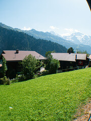 Alpine wood cabin village with Big mountain in the back in the swiss Alps at Jungfrauregion Berner...