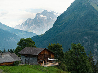 Fototapeta na wymiar Alpine Village in switzerland with view at Jungfrau region Top of Europe Wetterhorn Mountain Alps