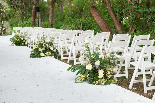 White chairs row on an outdoor wedding