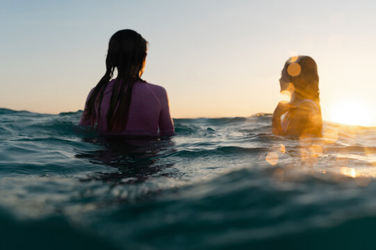 Dreamy image of swimmers in golden hour