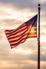Stars and stripes flag backlit by sunlight, USA