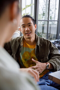 Handsome man talking with woman at cafe