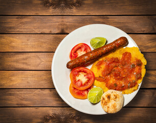 Sausage, patacon and sliced tomatoes, traditional Colombian breakfast