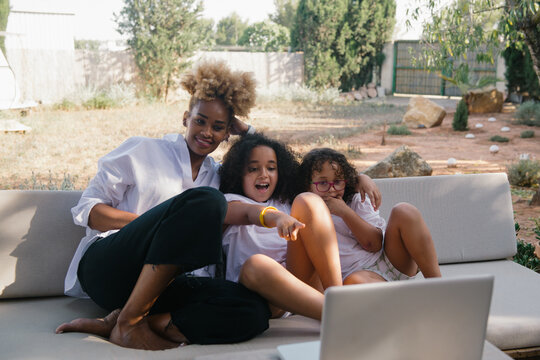 Mother with her two daughters using the computer