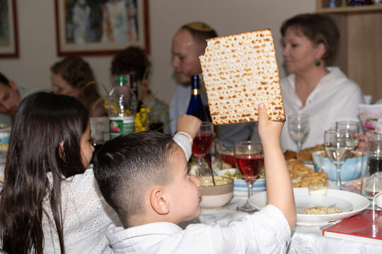 Afikoman Discovery. Boy Holding Afikomen, Passover Tradition.