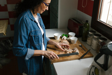 Woman is cutting some ingredients for cooking