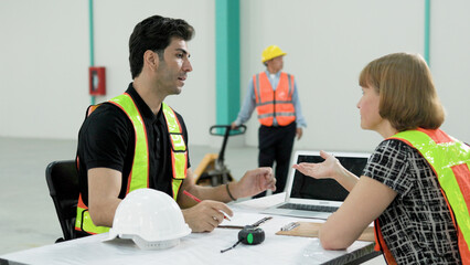 Female manager explains, discusses, discusses with young male engineers project plans factory work	