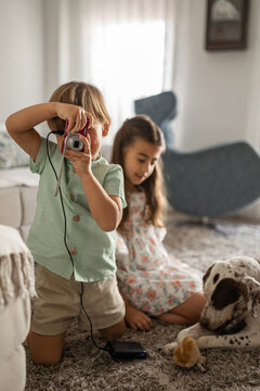 brothers with camera at home