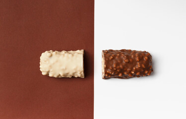 White and brown chocolate bars on contrasting backgrounds top view