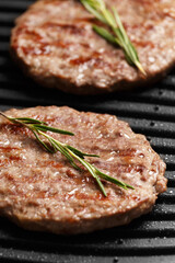Burger cutlets are fried on a smart electric grill, homemade burgers.