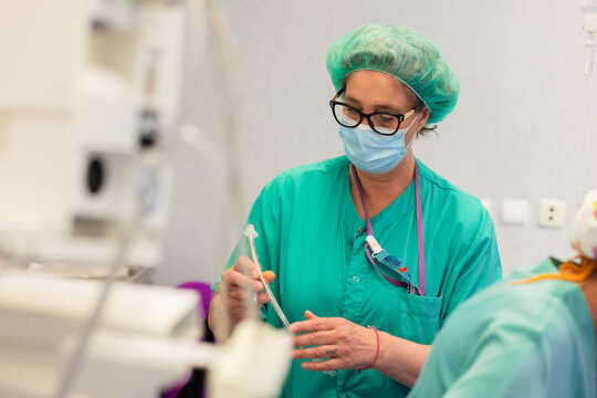 Woman in mask with tube preparing for surgery