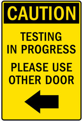 Testing in progress warning sign and labels please use other door