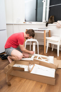 Man Assembling Furniture At Home