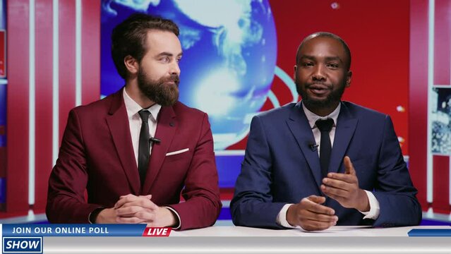 Diverse men hosting morning show live in news studio, team of reporters presenting global events on television program. Two coworkers doing breakfast tv segment to broadcast news.