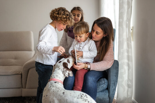 mother reading a story to her children at home