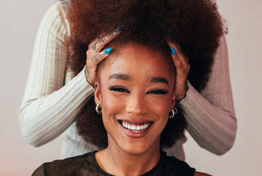 Cheerful black woman with colorful makeup