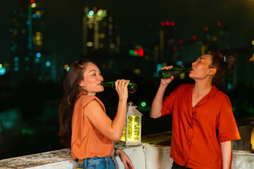Diversity Asian people friends drinking beer and talking together during having dinner party at...
