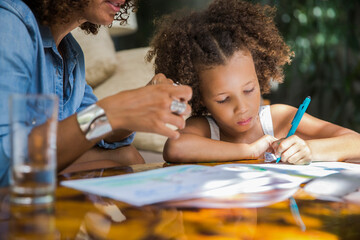 Daughter writing with mom