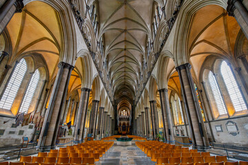 Interior view of the nave, altar, and columns in the Salisbury Cathedral, formally the Cathedral Church of the Blessed Virgin Mary, in Salisbury England. - obrazy, fototapety, plakaty