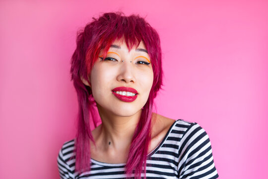 Female hipster with red lip in pink studio