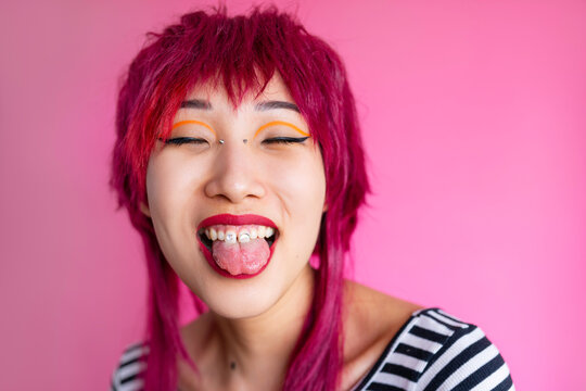 Female hipster with red lip in pink studio