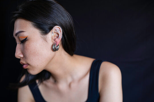 Young woman with makeup and ear piercing