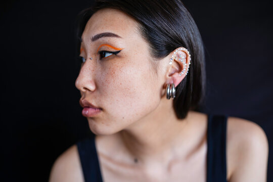 Young woman with makeup and ear piercing