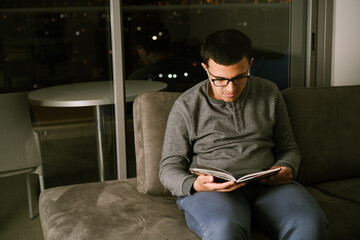 Young Teen Reading Book at Home.
