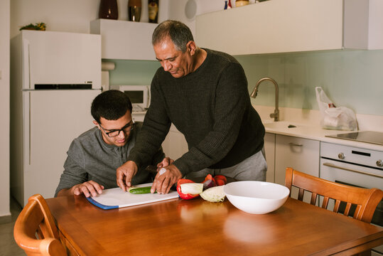 Empowering Independence,Grandfather and Boy Cutting Vegetables.