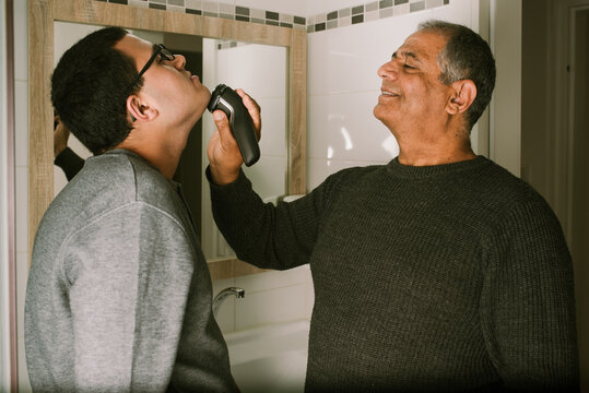 Grandfather Guides Teenager in Shaving Skills.
