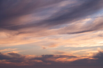 dramatic orange and dark purple clouds in the sky at sunset