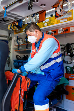vertical photo of a paramedic checking a medical backpac