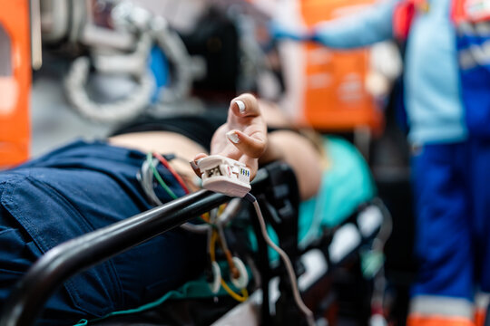 patient lying on an ambulance stretcher