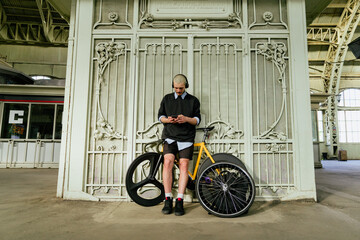 man on bicycle on train station travelling to countryside