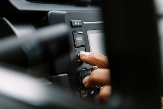 close up of finger pushing button in car