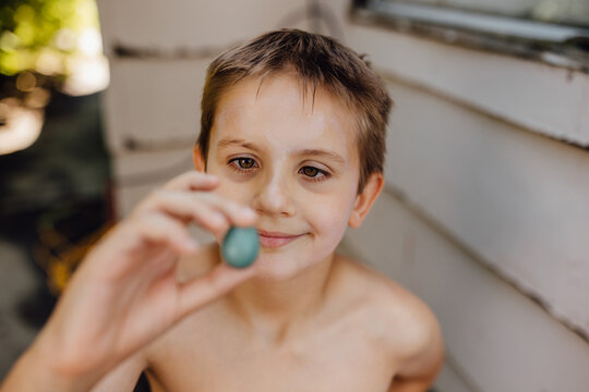 Child Finds Robin Egg Outside While Playing