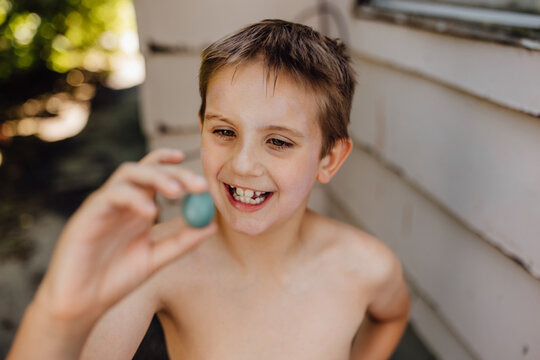 Child Finds Robin Egg Outside While Playing