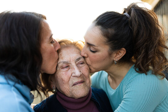 two women kissing grandma
