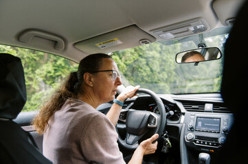middle aged woman getting inside her car to drive somewhere