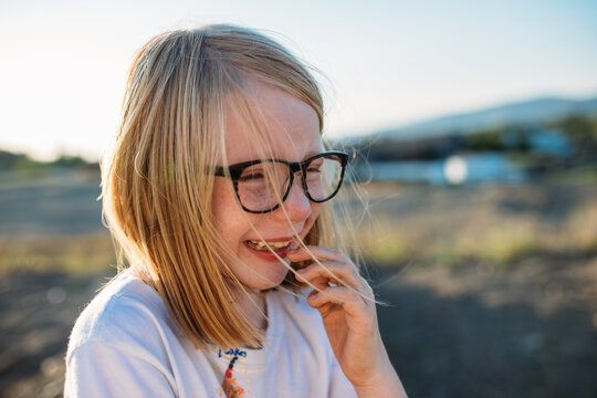 Close up portrait of young girl crying and laughing