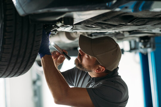 Mechanic Checking Car Tire Condition 