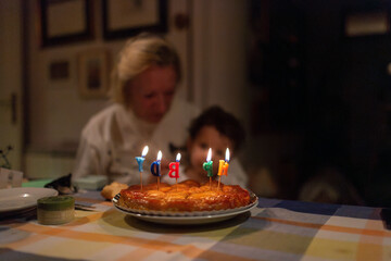 Grandma and baby blowing candles on birthday cake