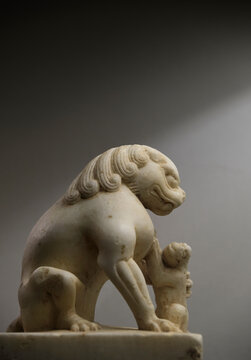 Closeup stone lion carved from white marble, decoration at home